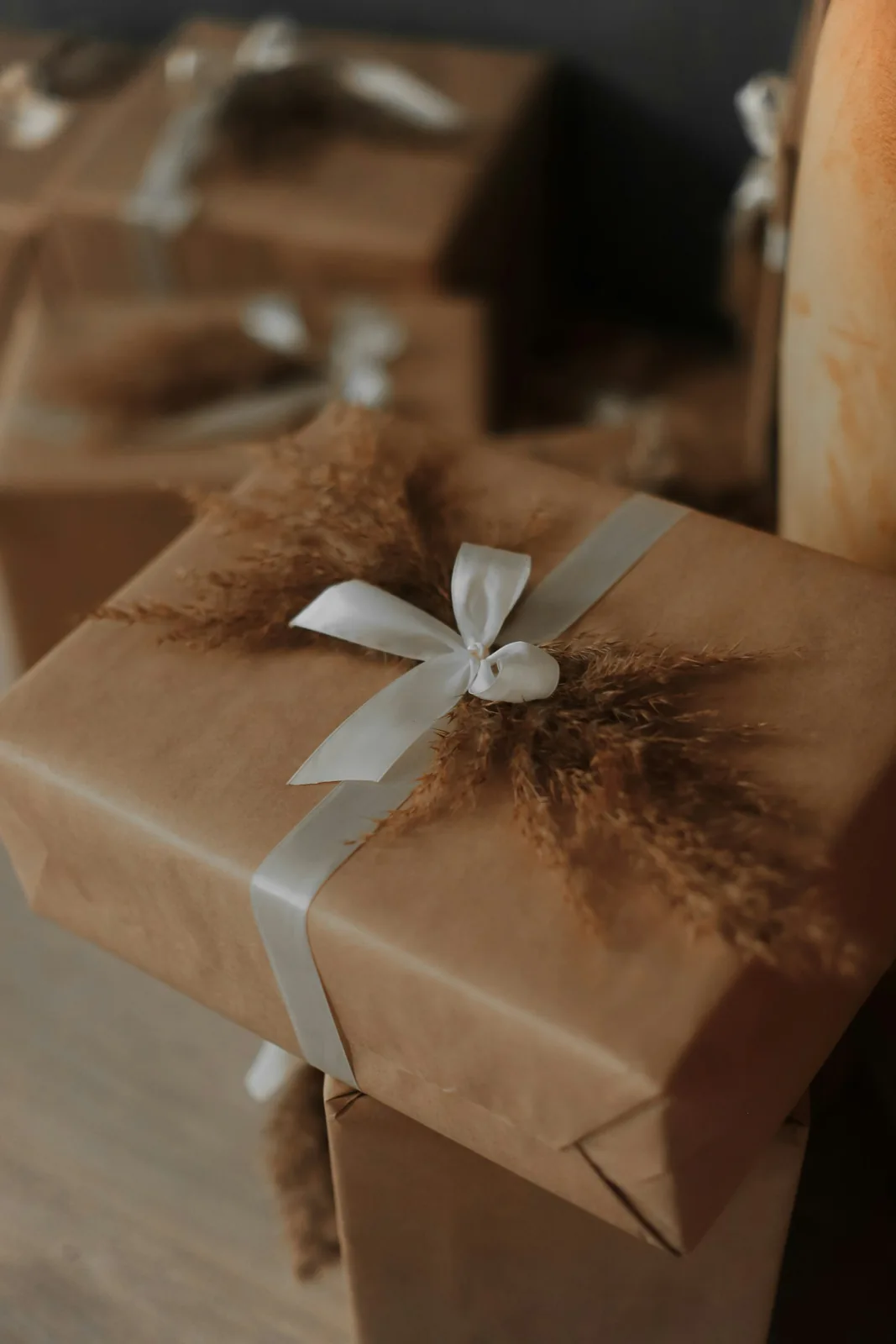 Gifts wrapped in brown paper with white ribbons