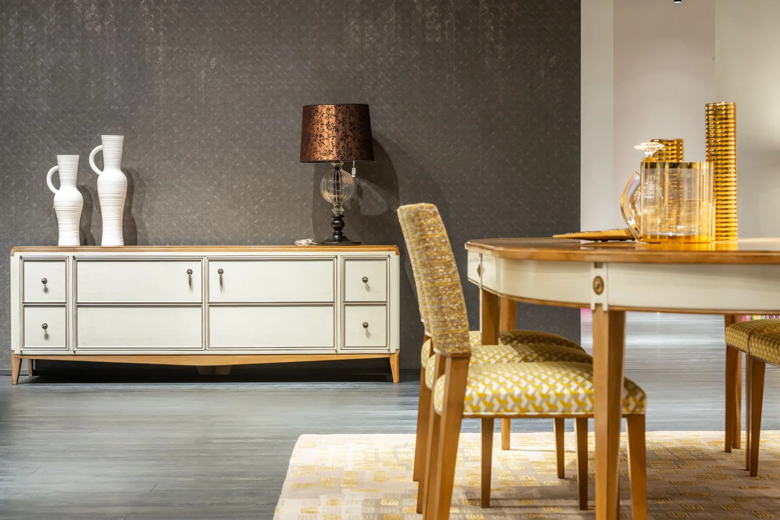 A dining area with an upholstered chair beside a wooden table