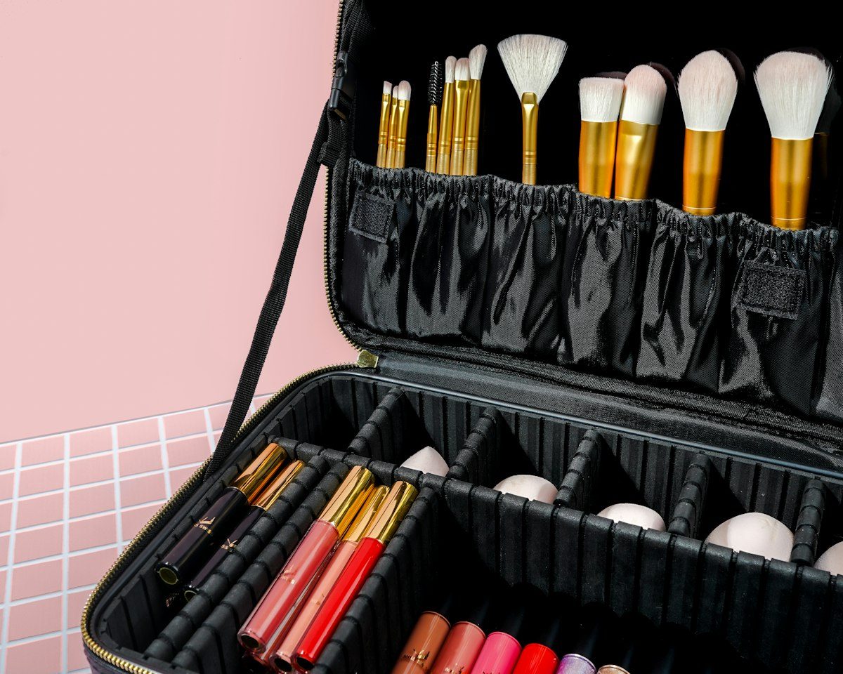 Makeup brushes and cosmetics organised inside an open travel case