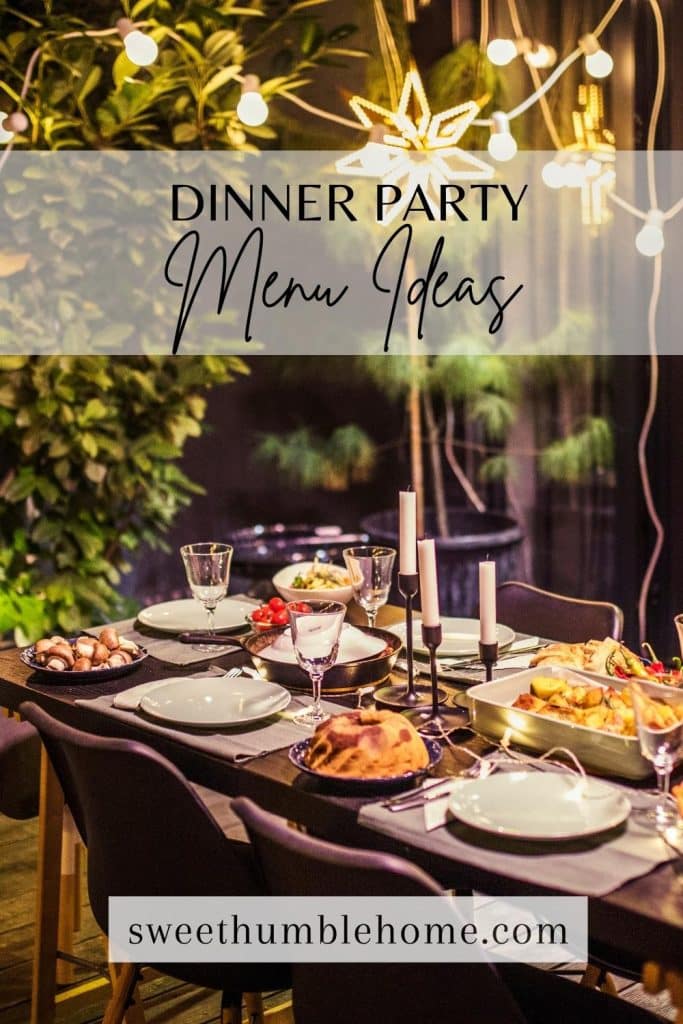 An outside table near a beautiful wooded area with places set for a dinner party and food staged on the table.