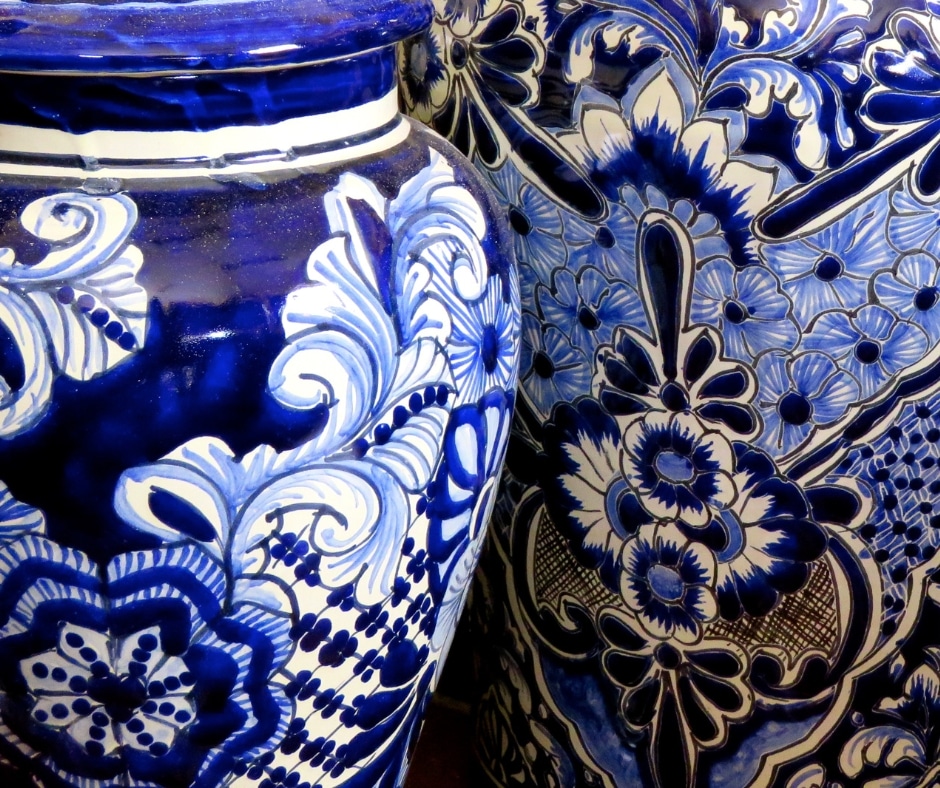 Close up of two chinoiserie vases. Blue and white flowers.
