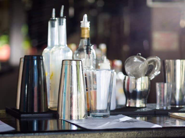Home Mocktail Bar Set up For a Party with a shaker, muddler, and other tools.