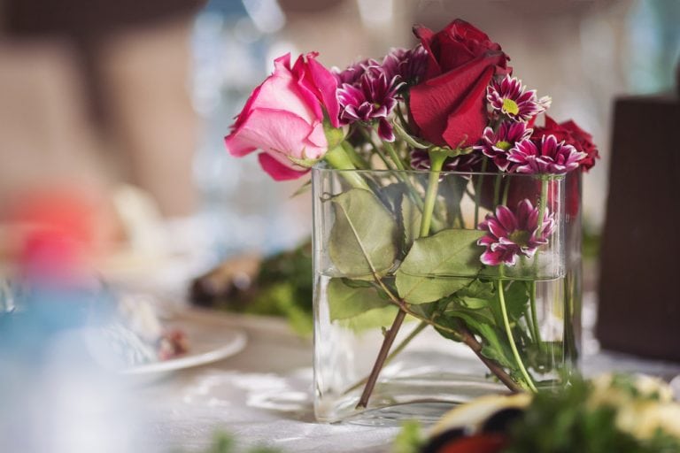 Simple, beautiful red and pink roses and daisies in a simple glass dish for the center of the Valentine's Day Table